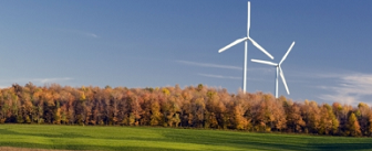 Photo of two windmills in a grassy field